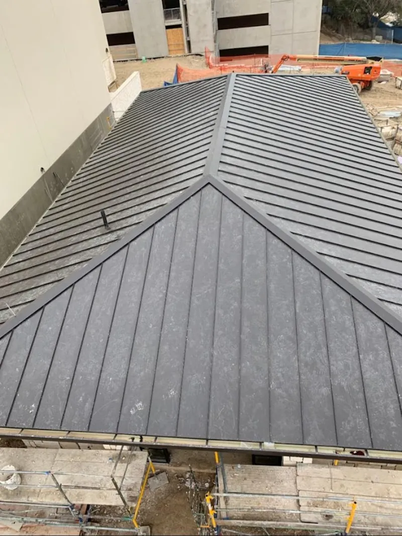 Commercial metal roof construction with crane equipment in Moorefield